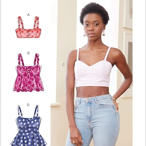 May include: McCall's sewing pattern featuring a woman wearing a pink and white gingham crop top. The pattern includes illustrations of various tops: a pink dotted top, a pink lace top, and a blue star-patterned top. The pattern number is M7958.