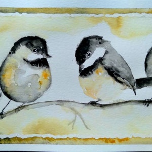 May include: Watercolor painting of three birds perched on a branch. The birds are gray and black with yellow accents. The background is a light yellow with a brown border.
