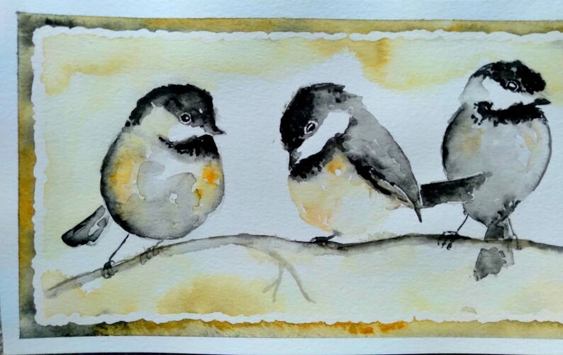 May include: Watercolor painting of three birds perched on a branch. The birds are gray and black with yellow accents. The background is a light yellow with a brown border.