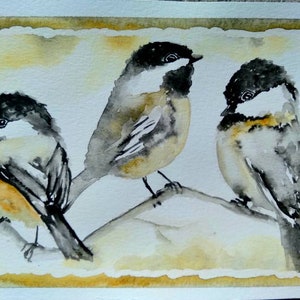 May include: Watercolor painting of three black-capped chickadees perched on a branch. The birds are painted in shades of gray, black, and white, with hints of yellow on their bellies. The background is a soft yellow.
