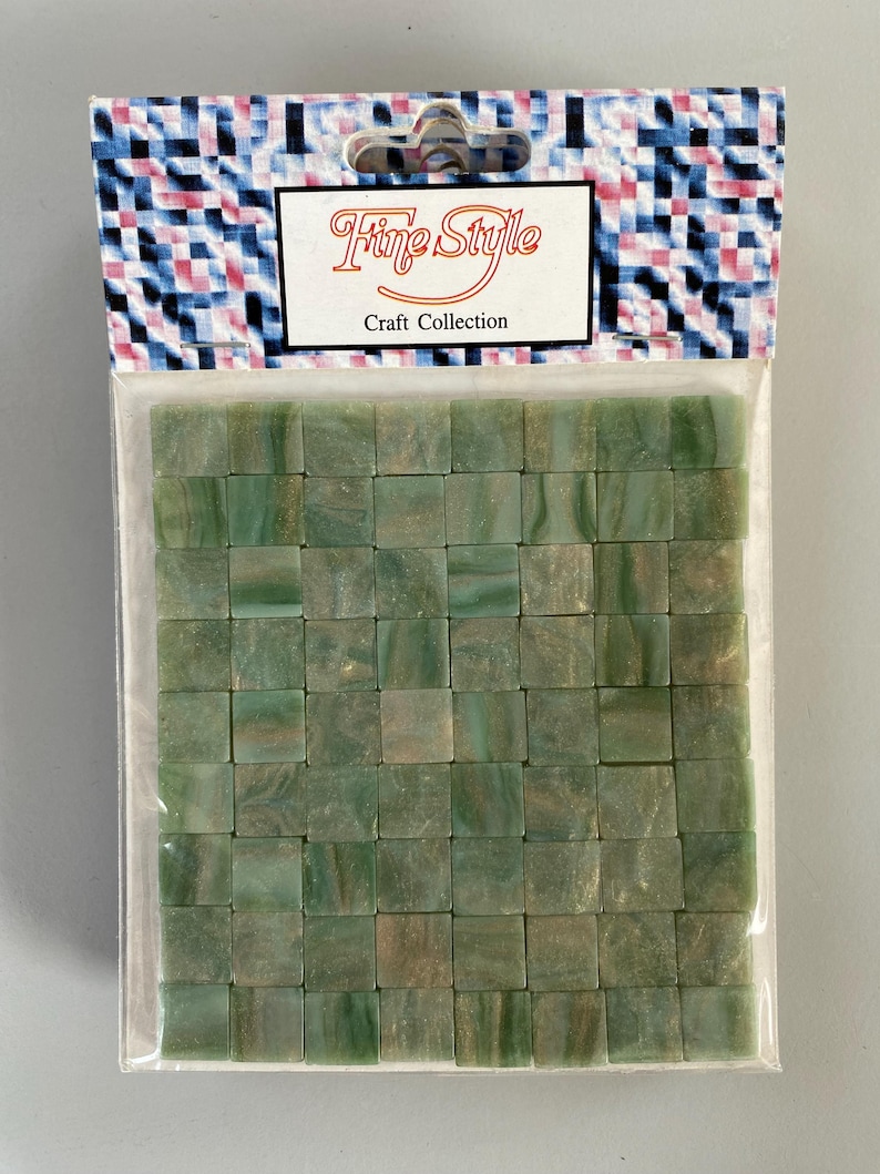 May include: A package of green and gold mosaic tiles. The package is labeled "Fine Style Craft Collection".