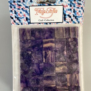 May include: A package of purple and white mosaic tiles. The package has a label that says "Fine Style Craft Collection".
