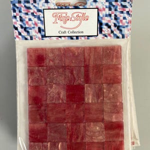 May include: A package of 36 red and gold mosaic tiles. The tiles are square and have a shimmery finish. The package says "Fine Style Craft Collection".
