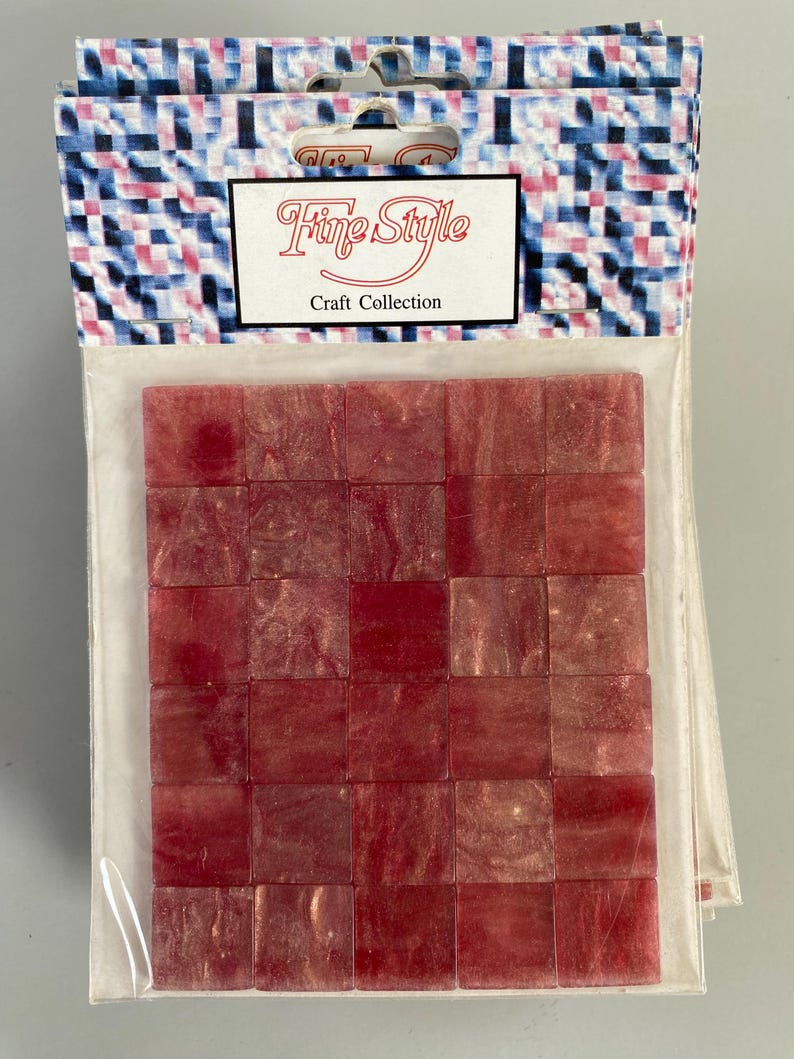 May include: A package of 36 red and gold mosaic tiles. The tiles are square and have a shimmery finish. The package says "Fine Style Craft Collection".