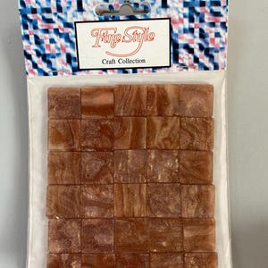 May include: A package of 36 small, square, brown mosaic tiles with gold flecks. The package is labeled "Fine Style Craft Collection".