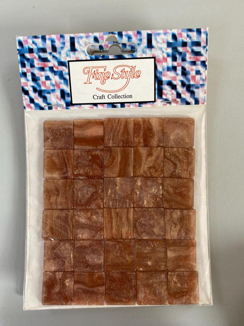May include: A package of 36 small, square, brown mosaic tiles with gold flecks. The package is labeled "Fine Style Craft Collection".
