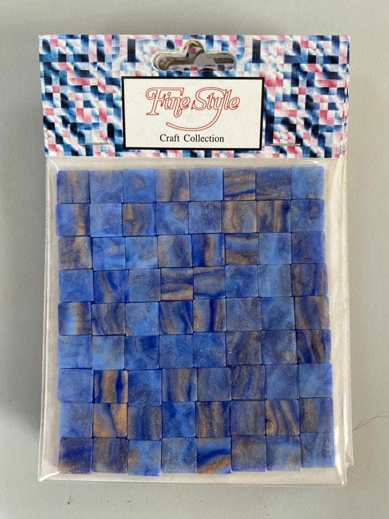 May include: A package of blue and gold mosaic tiles. The tiles are small, square, and have a marbled effect. The package is labeled "Fine Style Craft Collection".