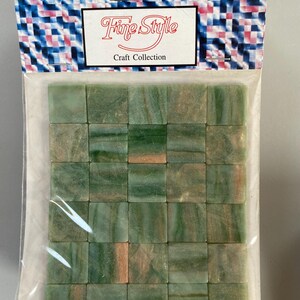 May include: A package of 36 green and brown mosaic tiles. The tiles are square and have a marbled look. The package is labeled "Fine Style Craft Collection".