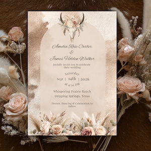 May include: A wedding invitation with a rustic, bohemian theme. The invitation features a cow skull with floral accents, and the names "Amelia Rose Carter & James Holden Walker". The date is September 14th, 2026, at 4:30 PM.