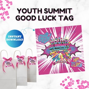 May include: White gift bags with pink ribbon and tags that read "Youth Summit Good Luck Tag." The tags have a pink and blue design with the words "Good Luck" and "Youth Summit Championship 2026."