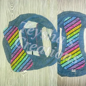 May include: A pair of blue denim underwear with a rainbow striped fabric insert. The insert has a glittery finish.