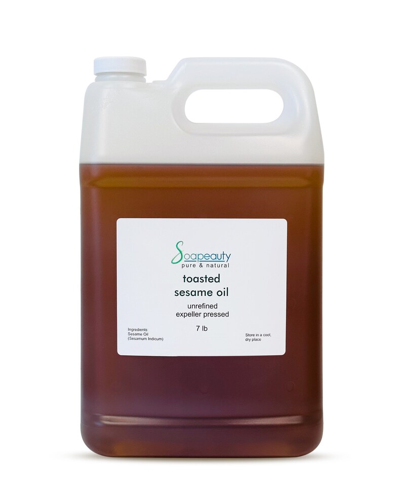 May include: A white plastic gallon jug filled with toasted sesame oil. The label reads "Soapeauty pure & natural toasted sesame oil unrefined expeller pressed 7 lb. Stone in a cool, dry place."