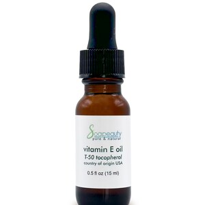 May include: A brown glass bottle with a black dropper top. The bottle is labeled "Soapeauty pure & natural vitamin E oil T-50 tocopherol country of origin USA 0.5 fl oz (15 ml)"