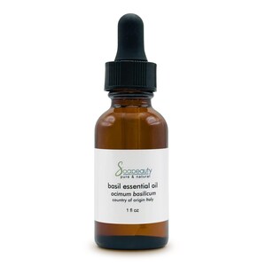 May include: A brown glass bottle of basil essential oil with a black dropper. The label reads "Soapeauty pure & natural basil essential oil ocimum basilicum country of origin Italy 1 fl oz."