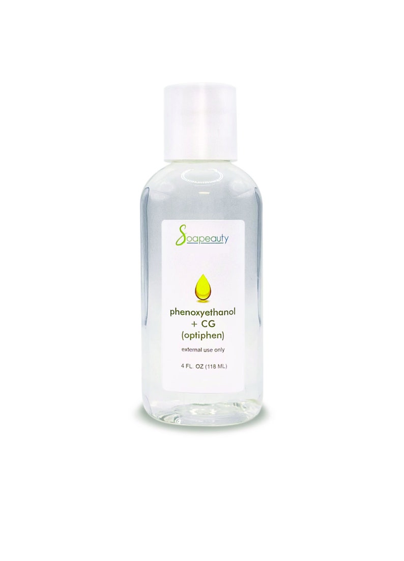 May include: A clear, rectangular bottle with a white cap, labeled "Soapeauty." The label includes the ingredients "phenoxyethanol + CG (optiphen)" and "4 FL. OZ (118 mL)." The bottle is filled with a clear liquid.