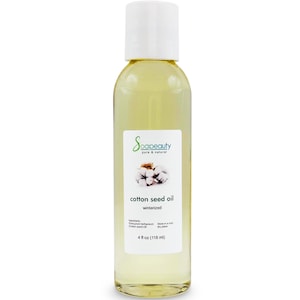 May include: A clear glass bottle with a white cap containing cottonseed oil. The label reads "Soapeauty pure & natural cotton seed oil winterized" and includes a cotton flower graphic. The bottle contains 4 fl oz (118 ml) of oil.