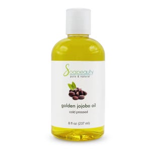 May include: A clear bottle of golden jojoba oil with a white cap. The label reads "Soapeauty pure & natural" and "golden jojoba oil cold pressed." The bottle contains 8 fl oz (237 ml) of oil and features an image of jojoba beans.