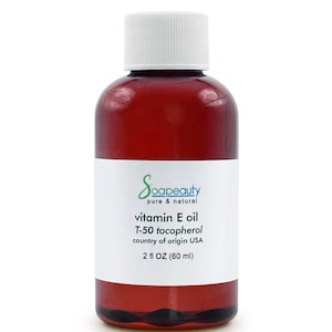 May include: A brown glass bottle with a white cap containing vitamin E oil. The label reads "Soapeauty pure & natural vitamin E oil T-50 tocopherol country of origin USA 2 fl OZ (60 ml)"