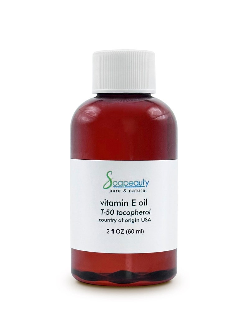 May include: A brown glass bottle with a white cap containing vitamin E oil. The label reads "Soapeauty pure & natural vitamin E oil T-50 tocopherol country of origin USA 2 fl OZ (60 ml)"