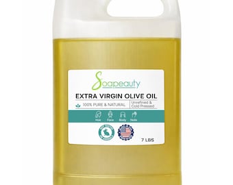 May include: A large, clear plastic jug filled with golden-yellow extra virgin olive oil. The label reads "Soapeauty" and lists the oil as 100% pure and natural, unrefined, and cold-pressed. The jug contains 7 lbs of olive oil.