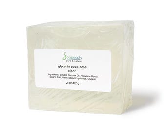 May include: A clear glycerin soap base wrapped in plastic. The label reads "Soapeauty pure & natural glycerin soap base clear" and lists the ingredients: Sorbitol, Coconut Oil, Propylene Glycol, Stearic Acid, Water, Sodium Hydroxide, Glycerin. The label also states "2 lb/907 g".