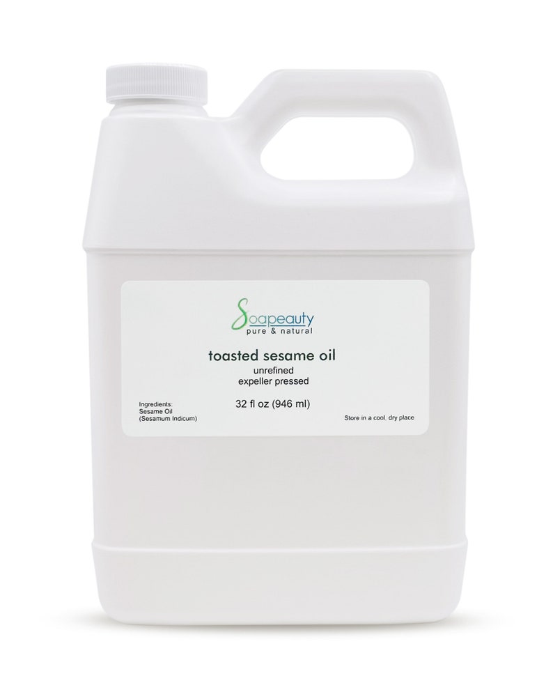 May include: A white plastic jug with a handle containing 32 fluid ounces (946 milliliters) of toasted sesame oil. The label reads "Soapeauty pure & natural toasted sesame oil unrefined expeller pressed 32 fl oz (946 ml) Store in a cool dry place".