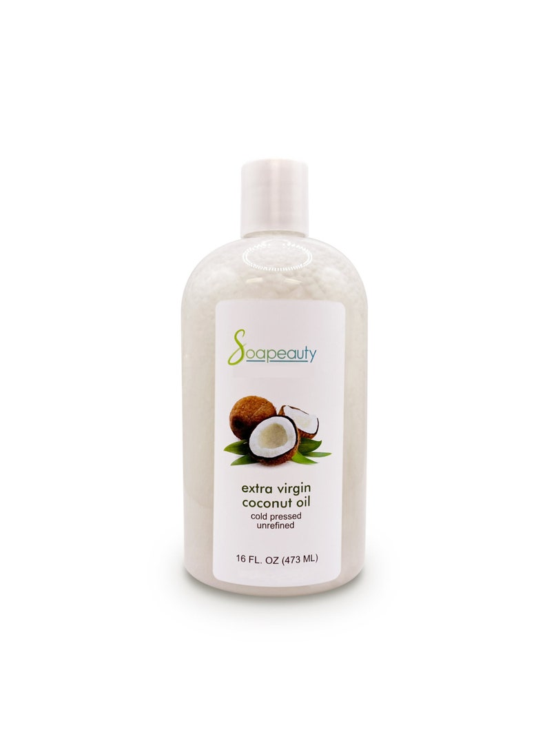 May include: A clear plastic bottle of extra virgin coconut oil, cold pressed and unrefined, with a white cap and a label that says "Soapeauty" and "16 FL. OZ (473 ML)". The bottle is sitting on a white background and has a picture of a coconut on the label.