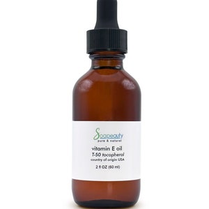 May include: A brown glass bottle with a black dropper top, labeled "Soapeauty pure & natural vitamin E oil T-50 tocopherol country of origin USA 2 fl OZ (60 ml)"