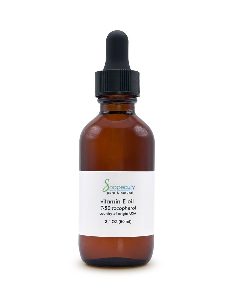 May include: A brown glass bottle with a black dropper top, labeled "Soapeauty pure & natural vitamin E oil T-50 tocopherol country of origin USA 2 fl OZ (60 ml)"