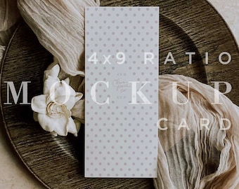 May include: A white card with a light purple polka dot pattern. The card is laying on a brown plate with a white flower and a beige fabric. The text on the card reads "4x9 Ratio Mock Up Card CPCO Images".