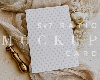 May include: A white card with a polka dot pattern and the text "5x7 Ratio Mockup Card" printed on it. The card is lying on a beige fabric with a gold-colored wax seal and a white flower.