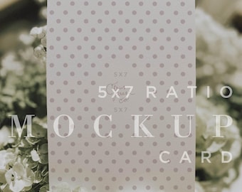 May include: A 5x7 ratio mockup card with a light gray polka dot pattern. The card is displayed on a bed of white flowers. Text on the card reads "5x7 Ratio Mockup Card" and "CPCO Images".
