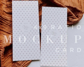 May include: Two white cards with a light gray polka dot pattern. The cards are laying flat on a white surface with a brown fabric draped over the top of the cards. The cards have the text "4x9 Ratio Mockup Card" printed on them.