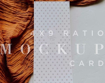 May include: A white card with a gray polka dot pattern. The card is 4x9 inches and has the text "4x9" and "Curated Press Co." printed on it. The card is lying on a white surface with a brown fabric draped over the top left corner.