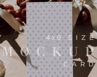May include: A vertical 4x9 inch card mockup with a light gray polka dot pattern. The words "MOCK UP CARD" are printed on the card. The card is next to a bunch of grapes and a white ribbon.