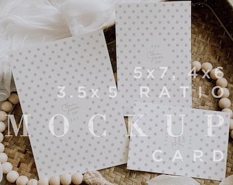 May include: Three cards with a polka dot pattern on a woven tray. The cards are different sizes, with the text "3.5x5", "5x7, 4x6 RATIO", and "CARD" printed on them. The cards are surrounded by a white fabric, a wooden bead garland, and a gold wax seal.