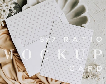 May include: A white card with a gray polka dot pattern and the text "5x7 RATIO MOCKUP CARD" on a beige fabric background.