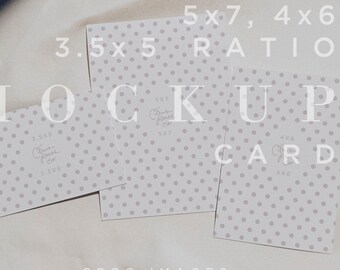 May include: A mockup card display featuring three cards with a gray polka dot pattern. The cards are arranged on a white surface with text that reads "MOCKUP CARD" and size ratios. A bunch of green grapes is visible in the corner.