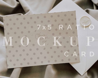 May include: A white envelope with a wax seal on a beige fabric background. A card with a polka dot pattern and the text "7x5 RATIO Citrus Press Co. MOCKUP CARD" is on top of the envelope.