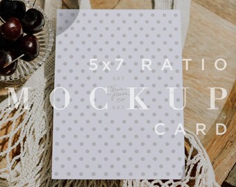 May include: A 5x7 inch mockup card with a gray polka dot pattern, displayed on a wooden surface. The card is labeled "5x7 Ratio Mockup Card". A glass of champagne and a bowl of cherries are also in the image.