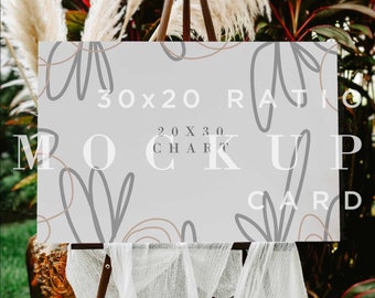 May include: A white card mockup on an easel with a gray background and the text "30x20 Ratio 20x30 Chart Card Mockup". The card is sitting on a white surface with a white cloth draped over the easel.