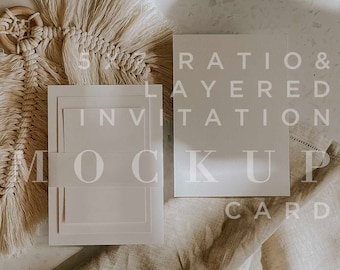 May include: A mockup of a layered invitation card with the text "Ratio & Layered Invitation Mockup Card". The card is on a beige surface with a white fabric and a macrame wall hanging.