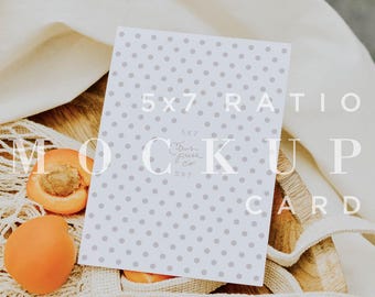 May include: A 5x7 ratio mockup card with a gray polka dot pattern, resting on a wooden surface. Two apricots and a mesh bag are also present. The card has the text "5x7 Ratio Mock Up Card" and "CPCO IMAGES".
