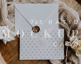 May include: A white envelope with a wax seal sits on top of a card with a polka dot pattern. The card has the text "Citrus Press Co." printed on it. The card and envelope are on a wooden tray with a white fabric draped over it.