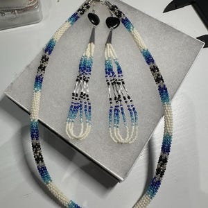 Beaded rope necklace and dangling loop style seed bead earrings. Indigenous made