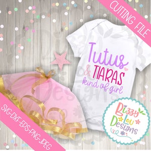 May include: A white onesie with the text "Tutus & Tiaras kind of girl" in purple and pink lettering. A pink tulle tutu with a gold ribbon is also pictured. The image includes the text "Cutting File" and "Bizzy Lou Designs".