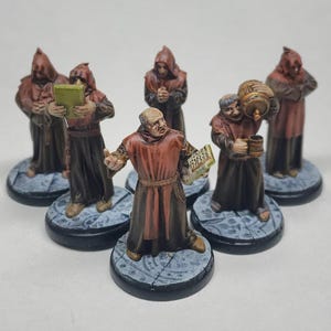 May include: Six painted miniature figures of monks wearing brown robes and hoods. The monks are holding books, a tankard, and a barrel. The figures are standing on round bases.