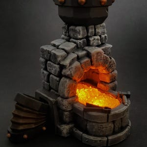 May include: A miniature forge with a glowing orange interior, constructed from gray stone blocks. The forge features a bellows on the side and a dark, cylindrical top with copper accents. The overall design suggests a fantasy or tabletop gaming theme.