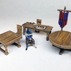 May include: A set of miniature wooden furniture for tabletop gaming, including a round table with four chairs, a square table with two chairs, and a long table with one chair. The furniture is painted in a rustic brown color and has a distressed finish.