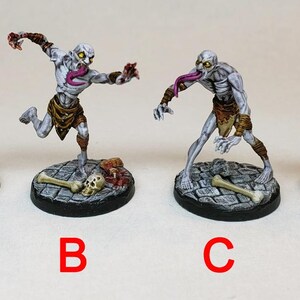 May include: Four painted miniature figures of undead creatures with long, pink tongues. The figures are posed in different positions and are standing on round bases with painted details.